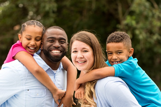 A family of four posing for the camera.