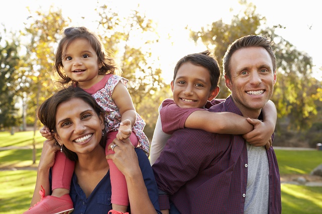 A family of four posing for the camera.