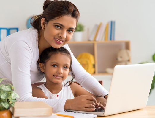 A woman and child are looking at the camera.